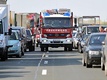Ein Feuerwehrfahrzeug f&auml;hrt durch eine Rettungsgasse im Stau hinter einer Unfallstelle auf der Autobahn. Auf der A1 bei L&uuml;beck h&auml;tte das so nicht geklappt - denn einige Autofahrer wendeten und fuhren durch die Rettungsgasse zur&uuml;ck.  Symbolfoto: Jan Woitas/dpa