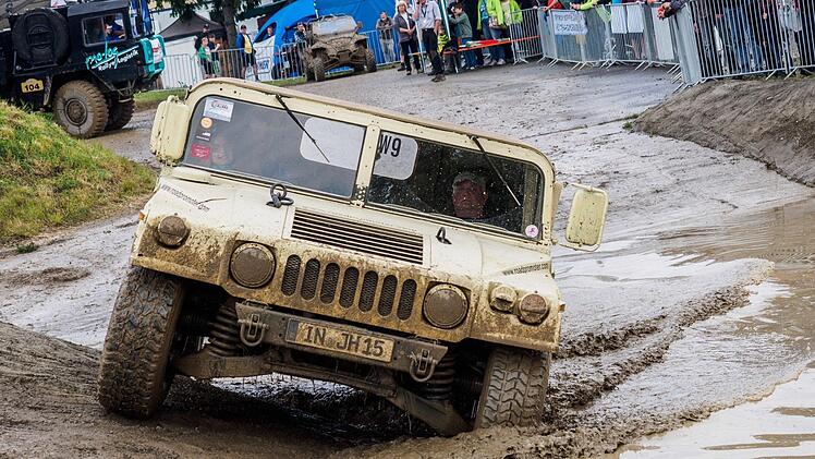 Ein Besucher fährt bei der Abenteuer & Allrad 2016 in Bad Kissingen mit einem Geländefahrzeug der Marke «Hummer» durch eine große künstliche Pfütze. Auf dem Gelände bei Reiterswiesen beginnt am 15. Juni 2017 die 19. Off-Road-Messe. Foto: Nicolas Armer/dpa