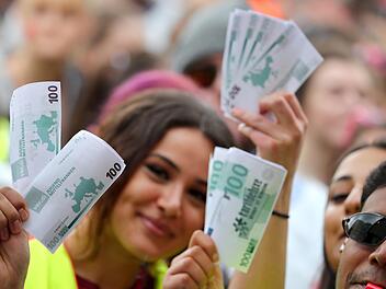 Zu der zentralen nordbayerischen Kundgebung waren auch Beschäftigte aus Bad Kissingen nach Nürnberg gereist. Hier  verdeutlichen Auszubildende im öffentlichen Dienst mit Spielzeuggeld ihre Forderungen nach einer höheren Vergütung. Foto: Daniel Karmann/dpa