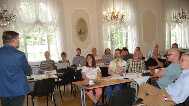 Dr. Herbert Barthel, Energiereferent des BUND Naturschutz Bayern (von links) erkl&auml;rt den zuk&uuml;nftigen Solarbotschaftern, wie man mehr Photovoltaik auf die D&auml;cher bekommen kann. Klaus Gerner