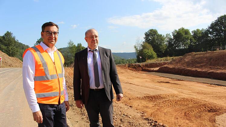Rüdiger Köhler (links) und Michael Fuchs begutachten die Baustelle. Links entsteht die neue Straße, während rechts die alte zurückgebaut wird. Foto: Julia Raab