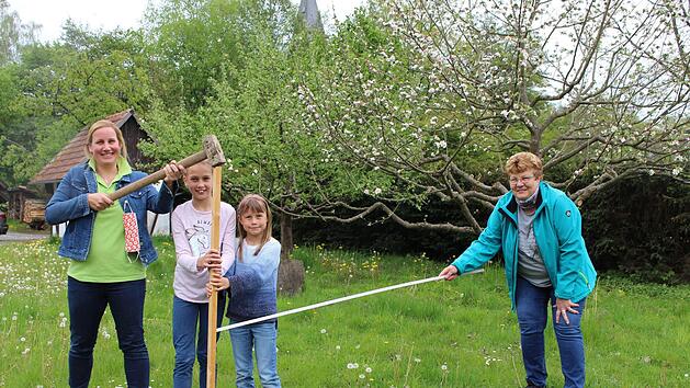 Symbolisch schl&auml;gt Britta Slowik (links) mit ihren T&ouml;chtern Pauline und Klara den ersten Zaunpfahl f&uuml;r das Jugendprojekt der Funky Fruits in den Boden. Monika Wiesner (rechts) unterst&uuml;tzt mit gebotenem Abstand. Foto: Julia Raab