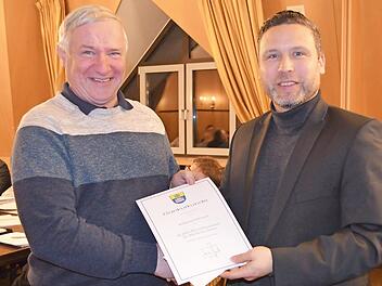 Bürgermeister Martin Finzel (rechts) gratuliert Wolfgang Harnauer zum Jubiläum 40 Jahre im öffentlichen Dienst, davon 26 Jahre bei der Gemeinde Ahorn. Vor allem Harnauers Einsatzbereitschaft als Wasserwart bei plötzlichen Störfällen findet hohe Anerkennung. Foto: Gabi Bertram