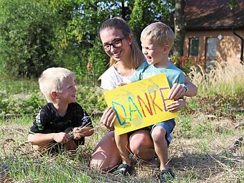 Zusammen mit Mutter Michaela Geisel und Bruder Lenny hat der sechsjährige Luca (rechts) ein Plakat für alle Helfer gebastelt.  Foto: Sarah Stieranka