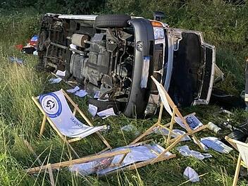 Der Kleinbus liegt auf der Seite, viele Gepäckstücke - auch Campingstühle - wurden herausgeschleudert. Foto: Feuerwehr Werneck