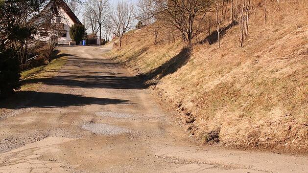 Die Straße An der Leite in Rugendorf ist marode. Im Gemeinderat ging es um die Frage, ob sie asphaltiert werden soll - und wer dafür die Kosten tragen müsste.