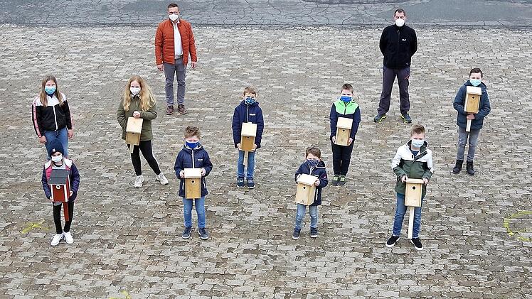 Die Kinder-Feuerwehr Hesselbach baute - auf Initiative ihrer Betreuer (hinten von links) Alexander Hoderlein und Harry Neder - Nistk&auml;sten f&uuml;r H&ouml;hlenbr&uuml;ter.