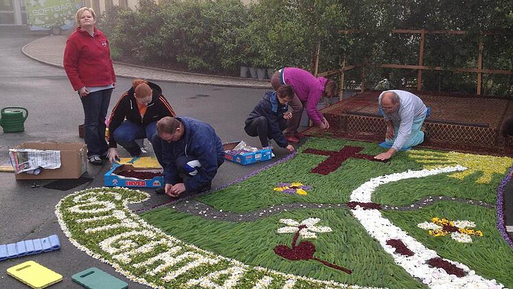 2012 wurde an Fronleichnam in Stadtsteinach ein Blumenteppich zum Thema "Gott geht alle Wege mit" gestaltet - mit einem Blumen- und einem steinigen Weg. Heuer stellt der Teppich eine Blume dar. Fotos: Sonja Adam