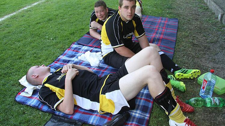 Relaxen nach Himmelkroner Art: Maxi Bekh (20) legt sich mal ruhig ab, Elfmeterkiller Patrick Jörn (22) und Marcello Jiggetts (19) müssen aber immer einen Blick aufs Spiel werfen.