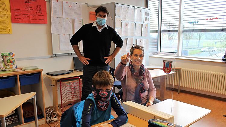 Wie Luca aus der Klasse 3a werden künftig alle Schüler der Grundschule Pommersfelden durch transparente Scheiben voneinander getrennt sein. Im Bild rechts Schulleiterin Cordula Schmeidl, hinten Bürgermeister Gerd Dallner.    Foto: Evi Seeger