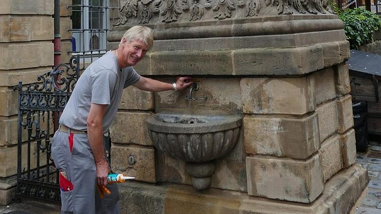 Aus dem Adlerbrunnen in Bamberg sprudelt frisches Trinkwasser, mit dem sich Touristen ihre Flaschen füllen können. Michael Schneider von den Stadtwerken hat die Qualität im Blick.  Foto: Stadtwerke Bamberg