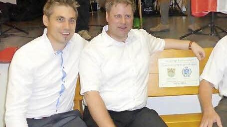 Eine Bank als Präsent zur Erinnerung an das 25-jährige Jubiläum hatte Bürgermeister Torsten Gunselmann (links) aus Hallerndorf mitgebracht. Auch Pfarrer Matthias Steffel (2. v. l.) war mit nach Italien gereist. Auf der Bank rechts freuen sich Zweiter Bürgermeister Sebastian Schwarzmann und Bürgermeister Walter Bortolotti (rechts).  Foto: Mathias Erlwein