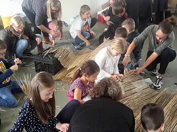 Jede Hand wurde gebraucht, als es beim Projekttag um den Bau von kleinen Insektenhotels ging. In Gemeinschaftsarbeit beteiligten sich Kinder, Eltern und Lehrer am exakten Zuschneiden des Rohmaterials aus gebrauchtem Bambusmatten.Foto: Rolf Pralle