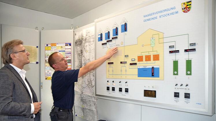 Auf dieser Tafel zeigt Wassermeister Werner Löffler (rechts) den Aufbau der Trinkwasserversorgung. Die sendet digital wichtige Daten für den Wassermeister aus den Tiefbrunnen und Hochbehältern, was vor allem bei Störungsfällen sehr wichtig ist, informiert er Bürgermeister Rainer Detsch.  Foto: Karl-Heinz Hofmann