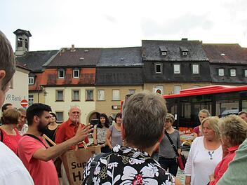 Das mittelalterliche Stadtsteinach auf der Rathausseite ist 1798 abgebrannt. Die jetzige Form der engen und gleichförmigen Bebauung (im Hintergrund) stammt aus dem frühen 19. Jahrhundert. NIcki Lang (links) und Wolfgang Martin (in roten Hemden) führten erstmals durch Stadtsteinach innerhalb der Stadtmauer. Foto: Klaus Klaschka