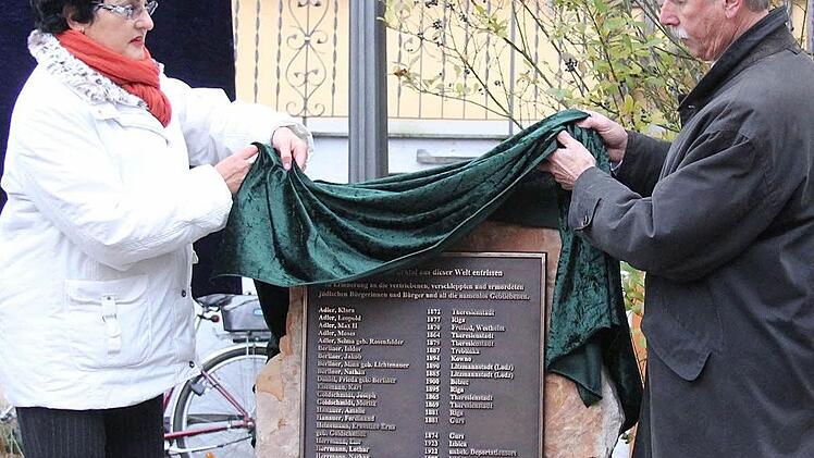 Zur Erinnerung an die Opfer des NS-Regimes: Die Westheimer Ortsbeauftragte und Stadträtin Gabi Ebert und Hammelburgs Bürgermeister Ernst Stross enthüllen den Gedenkstein.  Foto: Gerd Schaar