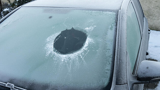 Winter Auto zugefrorene Frontscheibe mit Guckloch von einem Auto im Winter