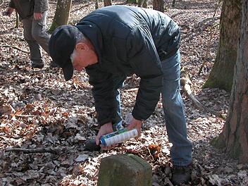 Erst werden die Grenzsteine freigelegt und dann mit Farbe markiert.  Foto: Ewald Kiesel