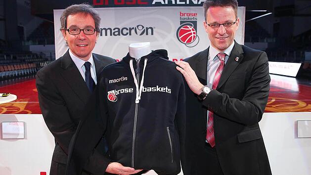 Roberto Casolari (l.), Sport-Marketingdirektor bei Macron, und Rolf Beyer, Gesch&auml;ftsf&uuml;hrer der Brose Baskets, gaben am Montag in der Brose Arena die neue Partnerschaft bekannt. Foto: Daniel L&ouml;b
