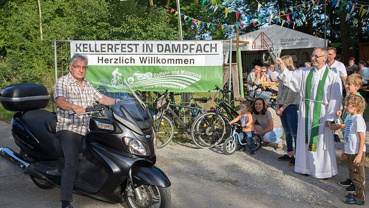 farrer Dr. Christian Lutz segnete nach dem Gottesdienst zu Beginn des 21. Kellerfestes des Radfahr- und Motorsportclubs "Viktoria 1912" Dampfach die anwesenden Motorrad- und Fahrradfahrer. Unser Bild zeigt) Klaus Mayer (links) und Pfarrer Lutz (rechts).