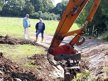 Bürgermeister Dieter Adam (links) und Ingenieur Dieter Wagner begutachten die vom Bagger geformte Erdmulde. Sie soll das Regenwasser von der Wohnbebauung im Steinloch abhalten und kontrolliert abführen.  Fotos: Jochen Nützel