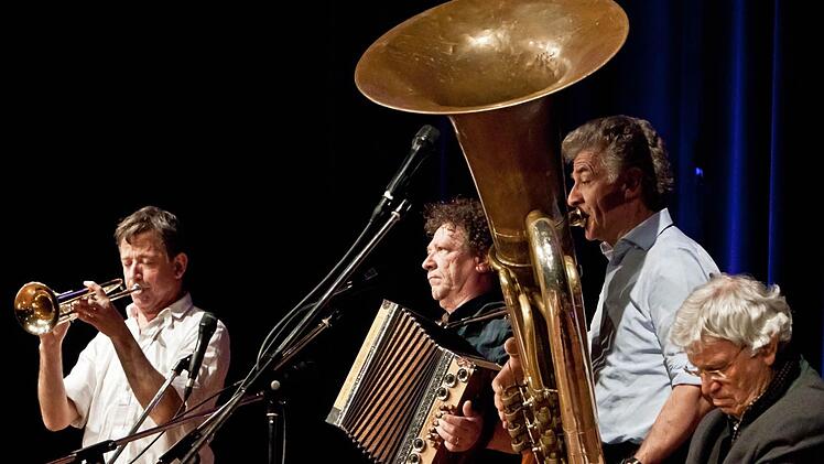 Während die Wellbrüder Christoph, Karli und Michael (von links) musizieren, sitzt Gerhard Polt scheinbar unbeteiligt auf der Bühne. Fotos: Jochen Berger