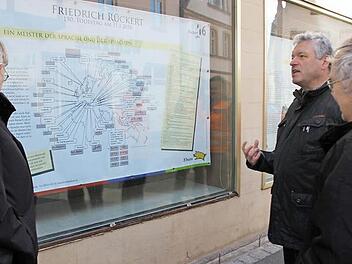 Diese Sprachen, wie auf einem Plakat bei Schmitt-Zehender dokumentiert, übersetzte Friedrich Rückert, wie Kreisheimatpfleger Günter Lipp, Bürgermeister Jürgen Hennemann und Ingo Hafenecker (im Bild von links) erklärten. Foto: Ralf Kestel