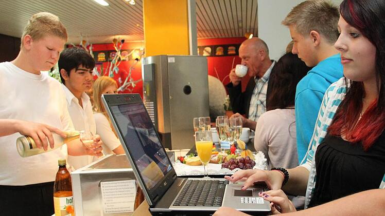 Mit modernen  Medien  an der  Kaffeebar:      Justine  (rechts), die beim Bau  des Schüler-Cafés   geholfen hat, wirft einen Blick in den  Computer.   Maximilian und Emre (von links) gehören zum Team  der künftigen  Achtklässler, die das  Café  betreiben werden.  Foto:  Alexander Hartmann