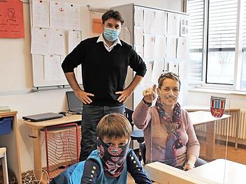 Wie Luca aus der Klasse 3a werden künftig alle Schüler der Grundschule Pommersfelden durch transparente Scheiben voneinander getrennt sein. Im Bild rechts Schulleiterin Cordula Schmeidl, hinten Bürgermeister Gerd Dallner. Foto: Evi Seeger