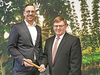 Herbert Sommerer (r.) übergibt die Leitung der Sparkassenfiliale symbolisch an Tino Keßler.