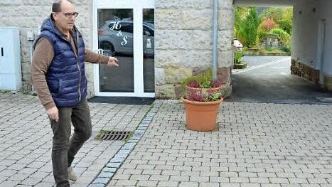 Detlef Heerlein zeigt die Pflanzkübel, die die Ausfahrt von der Bretschneider-Anlage zum Arnoldplatz sicherer machen sollen.