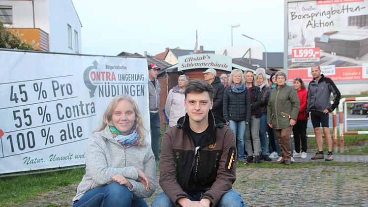 Christine Fell und Felix Schäfer (vorn) von der BI Contra Ortsumgehung mit Unterstützern am ersten von vier neuen Protestbannern. Foto: Benedikt Borst