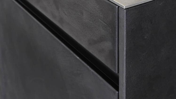 Anspruchsvoll: Die fünf Millimeter starke Edelstahl-Arbeitsplatte bildet einen interessanten Gegenpol zu der Feinbetonoberfläche der Küchenmöbelfront.  Fotos: AMK