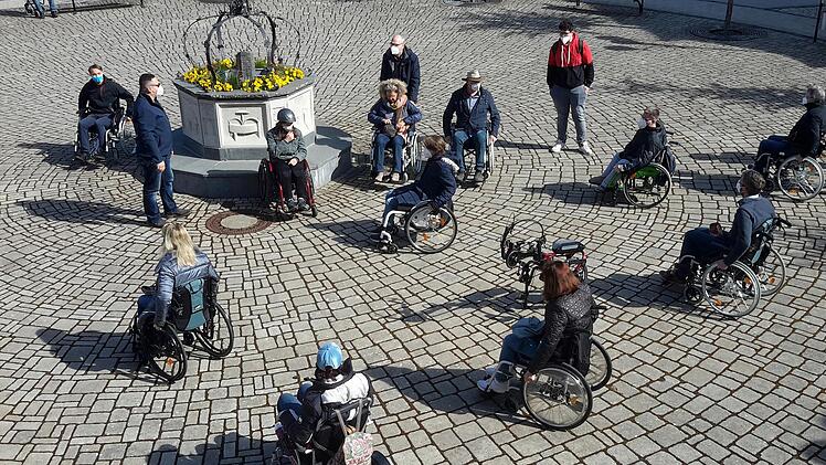 Mit dem nötigen Corona-Abstand formierten sich die Teilnehmerinnen und Teilnehmer an der an der Erkundungstour per Rollstuhl vor dem Alten Rathaus in Bad Brückenau. Die Veranstaltung sollte einen Eindruck davon vermitteln, mit welchen Hürden Behinderte in der Stadt zu kämpfen haben.Foto: Rolf Pralle