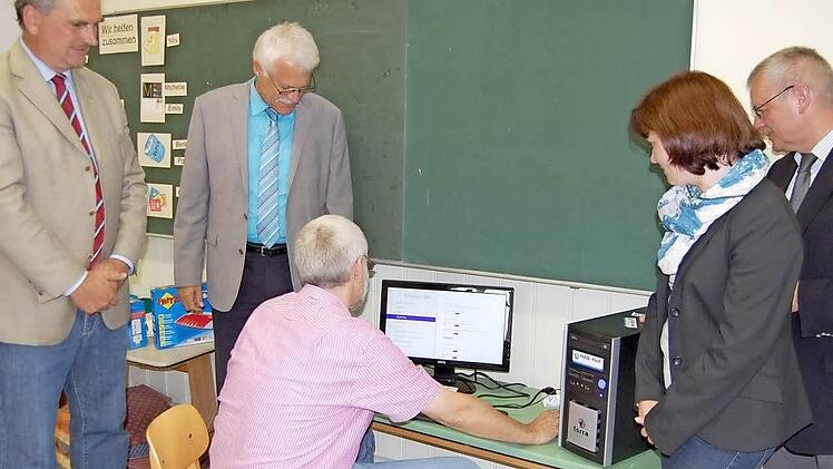 Roland Günther testet den neuen PC. Von Links: Rektor Hans-Jürgen Hanna, Geschäftsführer der Stadtwerke Norbert Kühnl, Nicole Wehner von der Gemeinde und Bürgermeister Gotthard Schlereth.  Foto: Günther Straub