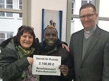 Petra Rohracker übergab an Patrick Niyigena eine Spende über 2150 Euro, über die sich auch Dekan Andreas Krefft freute. Foto: Sofia Trammer
