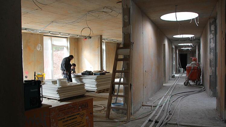 Stück für Stück nimmt der Wohnbereich für Menschen mit Behinderungen Gestalt an. Die Fassade des Gebäudekomplexes (Bild unten) ist schon fast fertig. Foto: Ulrike Müller