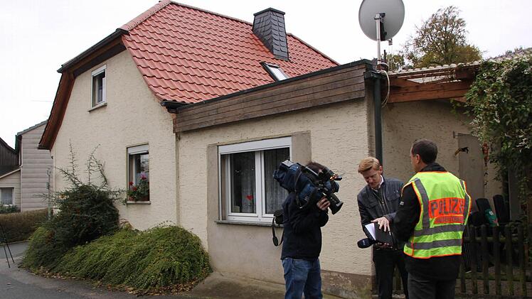 Polizeipressesprecher Manuel Stumpp erläutert vor dem Haus des Opfers den Tathergang. Fotos: Matthias Einwag
