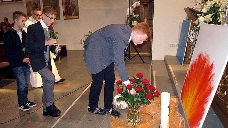 Die Firmlinge schmückten das Element Feuer als Sinnbild für den Heiligen Geist mit Rosen und gaben ihr Firmopfer für die Diaspora. Von links Daniel Stumpf, Maik Förner und Nico Schlee. Foto: Susanne Deuerling
