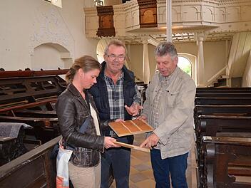 Kirchenpfleger Heinrich Nüßlein (rechts im Bild) mit Josef Denzlein, zuständig für die Schreiner und Holzarbeiten in der Kirche, und Diözesanarchitektin Petra Postler bei der Bemusterung des Holzes für die Bankpodeste. Foto: Andrea Spörlein