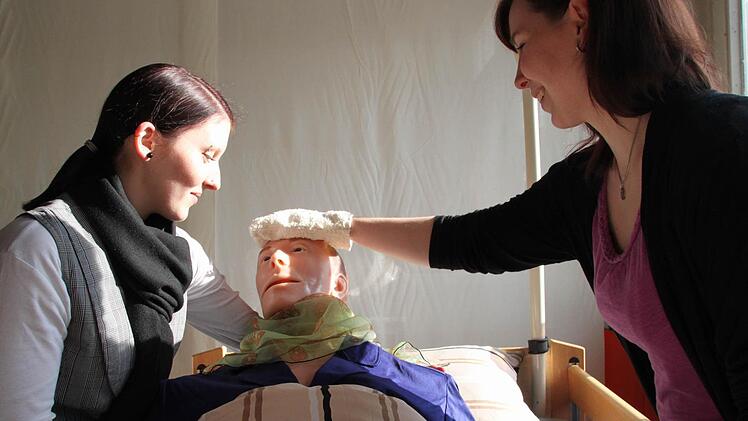 Anja Uridil (links) und Jasmin Schoberth gehören zur Examensklasse der Altenpflegeschule. Sie demonstrieren beim Tag der offenen Tür die Arbeit in einer Palliativstation. Fotos: Jürgen Gärtner