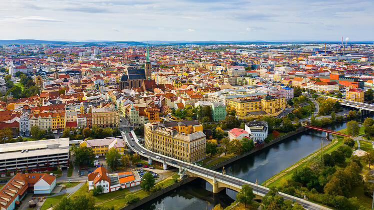 Picturesque aerial view of old buildings of Pilsen cityscape with river and ponds