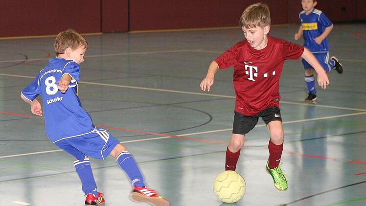Der Eberner Linus Dietz (rotes Trikot) umkurvt im Turnier der F-Jugend seinen Gegenspieler vom TSV Unterlauter. Die Eberner gewannen mit 4:1.