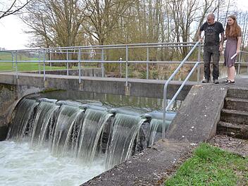 Martina Och und Vincente Junge stehen auf dem Stauwehr vor ihrer Mühle in Schleifenhahn  an der Itz.Rainer Lutz