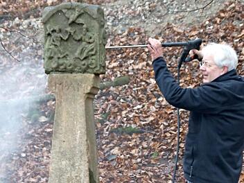 Der Bildhauer Michael Scholl bei seiner Arbeit: Mittlerweile ist der Bildstock nahe der Schönbachsmühle restauriert.  Foto: Ewald Kleinhenz
