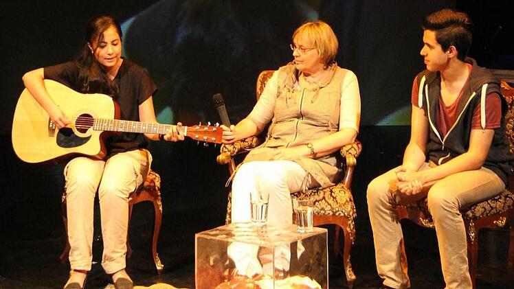 Heike Stegner-Kleinknecht (Mitte) berichtete, wie die Neustadter Mittelschule Am Moos versucht, die Talente ihrer Schüler zu fördern. Ntergia Recepoglou mitihrem selbstkomponierten Lied und Alperen Arik waren stellvertretend für die Schüler auf der Bühne. Foto: Simone Bastian