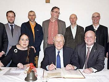 Festakt zur Errichtung der Rudi Jung Stiftung zur Förderung des Kinder- und Jugensports in Bischofsheim und zum Erhalt der Kirchenorgel der Stadtpfarrkirche St. Georg und Übergabe der Ehrenbürgerwürde. Das Bild zeigt Karla und Rudi Jung mit Bürgermeister Georg Seiffert beim Eintrag in das Goldene Buch der Stadt Bischofsheim. Stehend im Bild von links: Peter Suckfüll (stellvertretender Landrat), Michael Beer (RWV Haselbach), Gunnar Schatz (TSV Bischofsheim), Axel Braun (VfR Stadt Bischofsheim)...