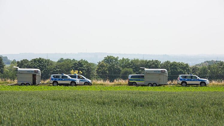 Polizeifahrzeuge und zwei Pferdetransportanhänger stehen auf einem Feldweg bei Wiesbaden-Erbenheim. Die Einsatzkräfte suchen nach einer vermissten 14-Jährigen. Foto: Ehresmann/Wiesbaden112/Ehresmann/Wiesbaden112.de/dpa