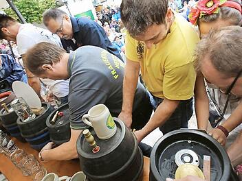 Knapp vor dem Einsetzen des großen Regens gelang den zehn Brauern der Bieranstich. Fotos: Barbara Herbst