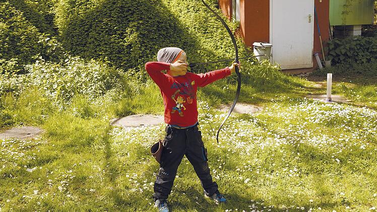 Ein Kind beim therapeutischen Bogenschießen